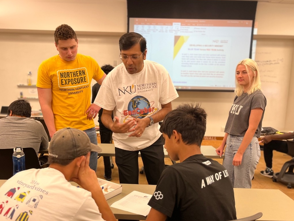 tNKU faculty, students, and community partners guiding high school-aged teens during Beginners' Cybersecurity Academy.