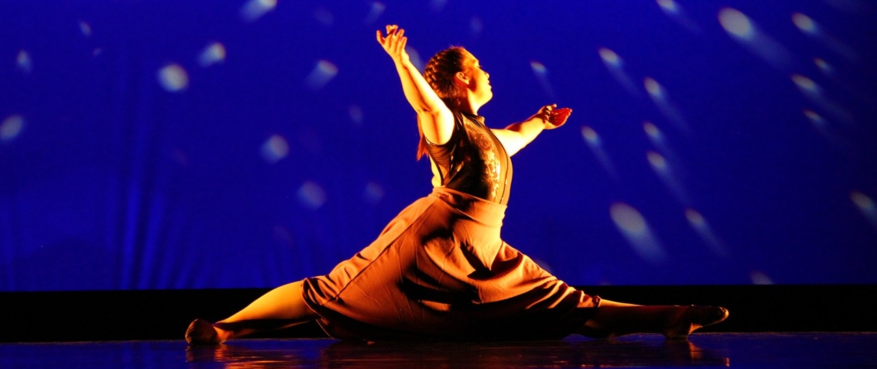 School of the Arts student performing on stage in a dance performance.