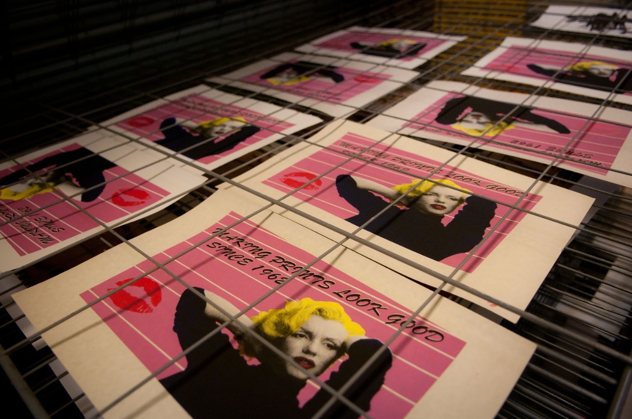 pink and yellow print of marilyn monroe with text surrounding the image