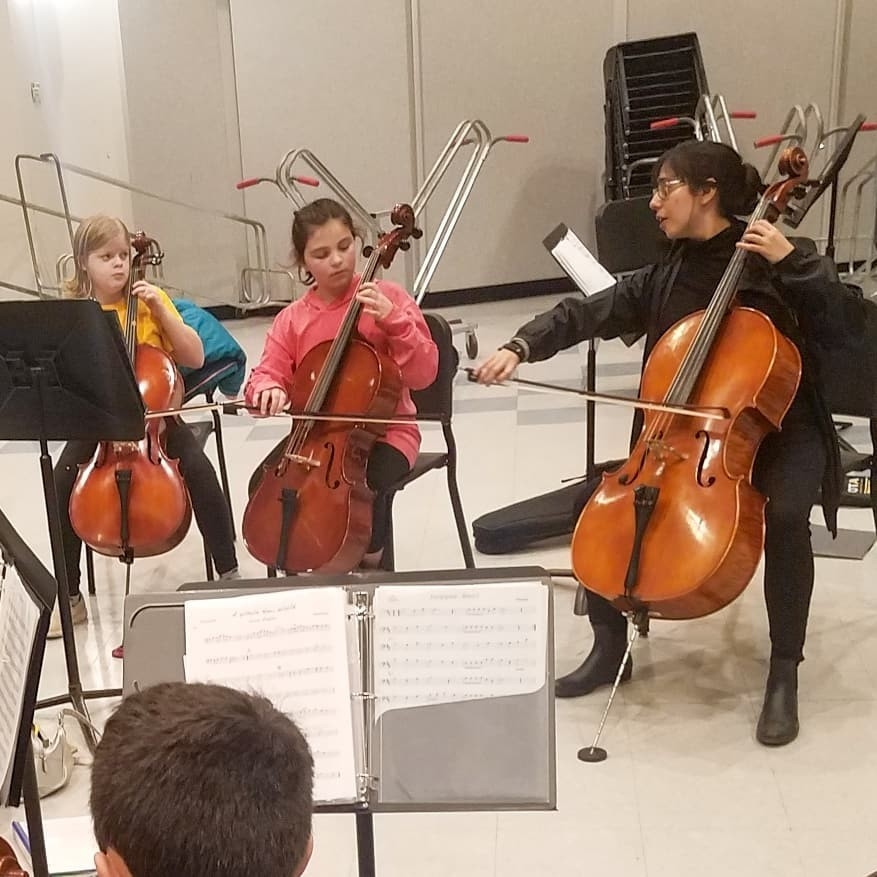 Cello players sitting together