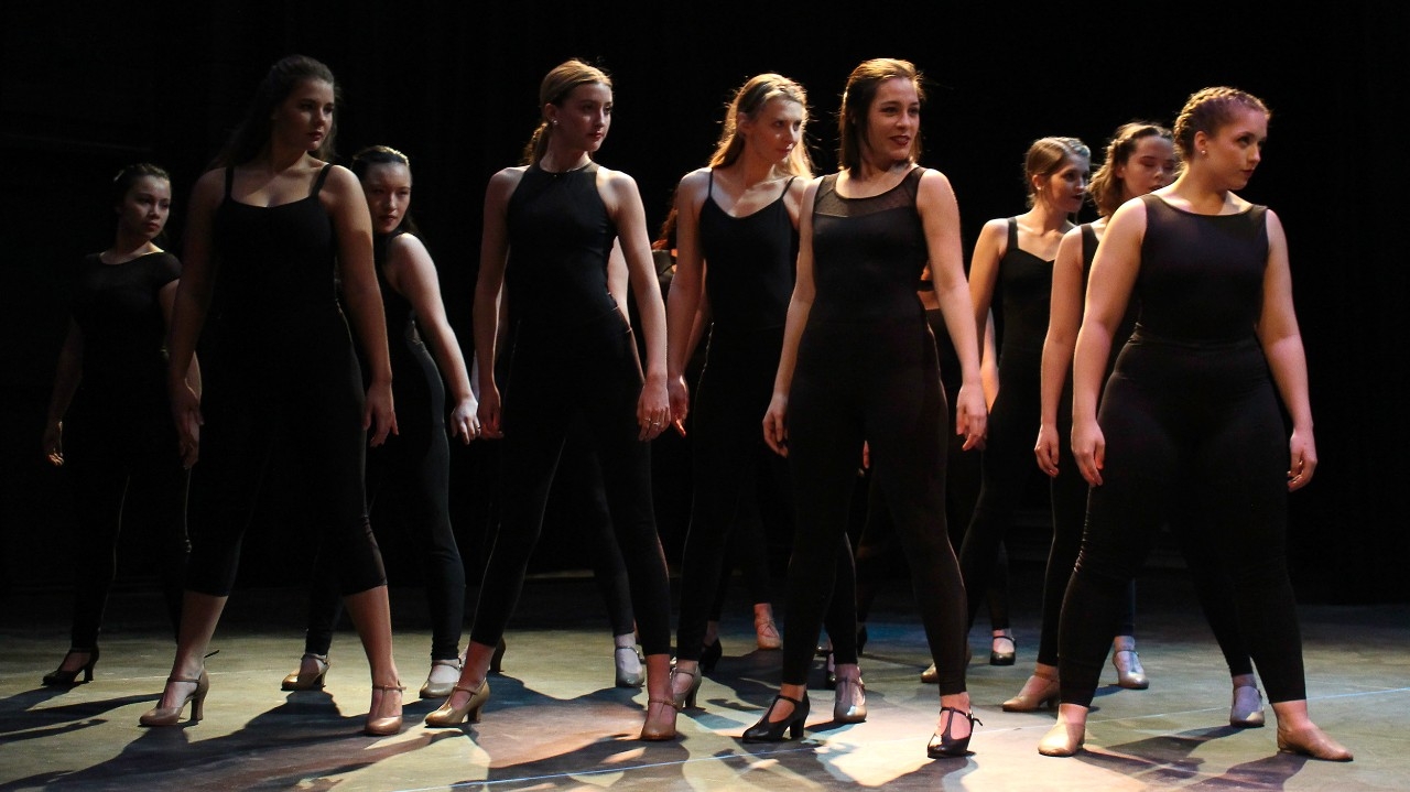 Dancers in a row posing
