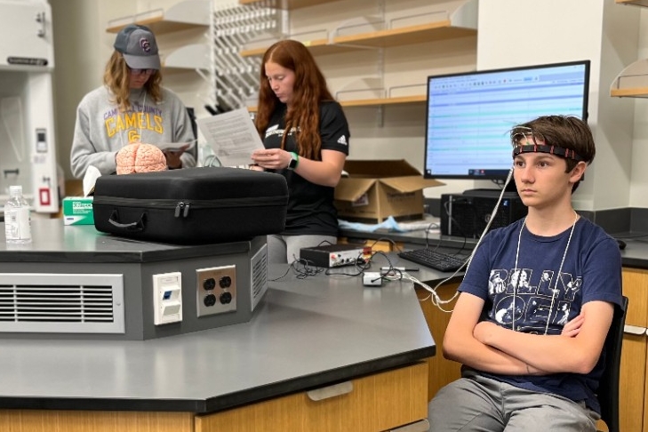 High school aged students doing neuroscience experiments in the lab