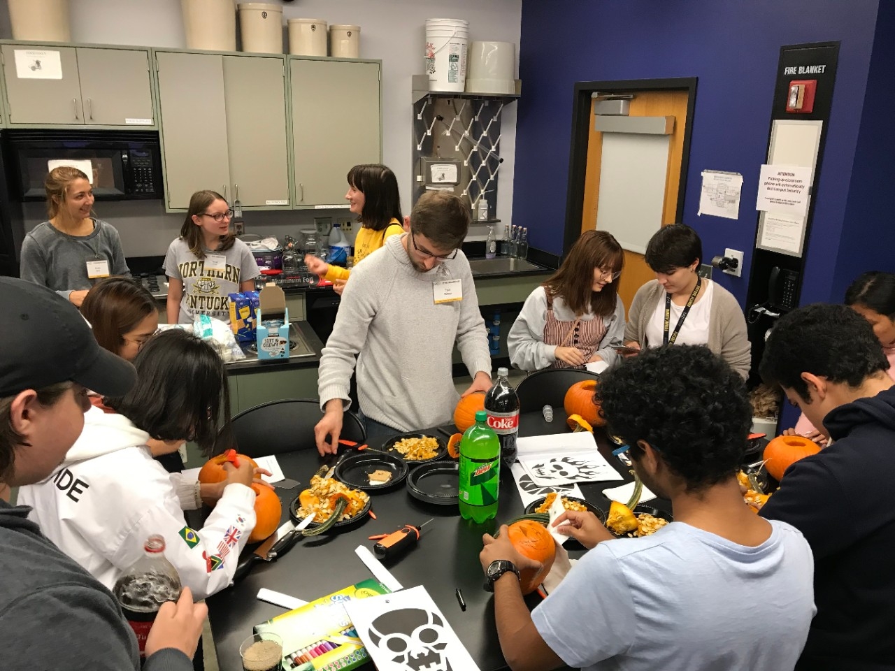 STEM students carving pumpkins together
