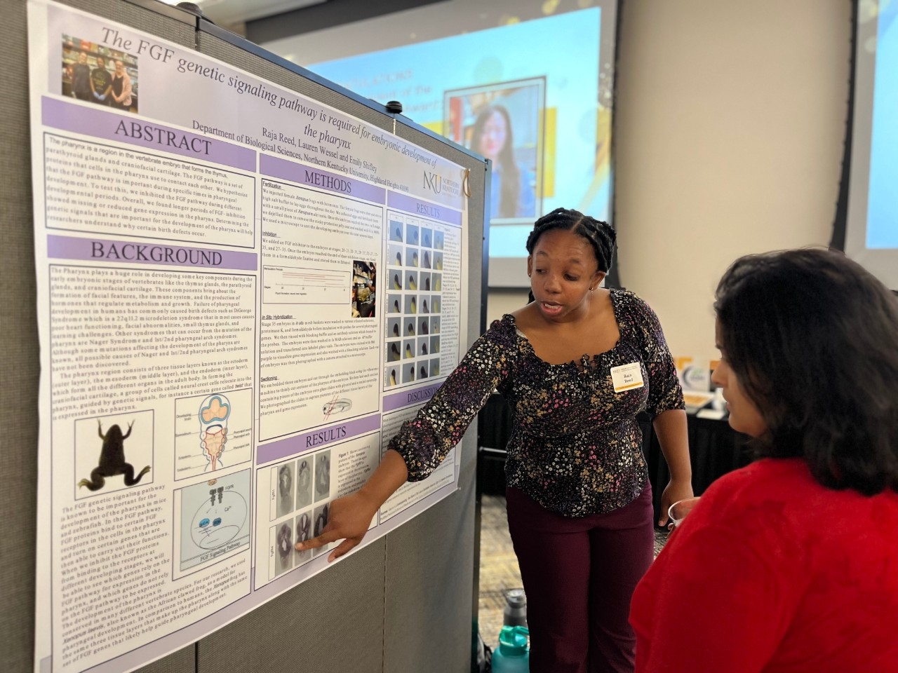NKU student presents research poster to a visitor