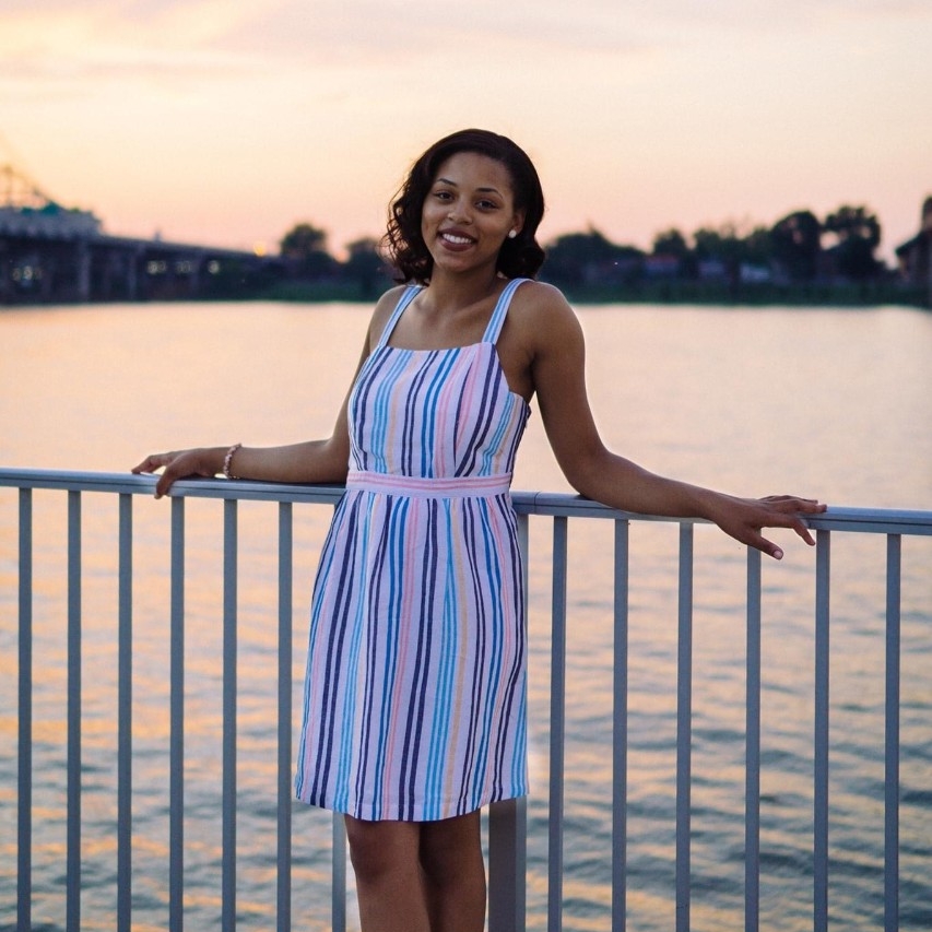 Rayah Ross smiles for the camera against a sunset