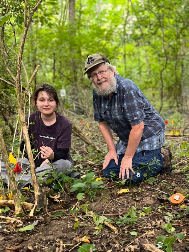 Dr. Boyce conducts field research with students in the woods.
