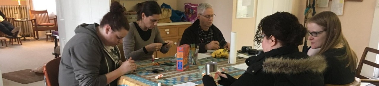 Image of creative writing students working at a breakfast table