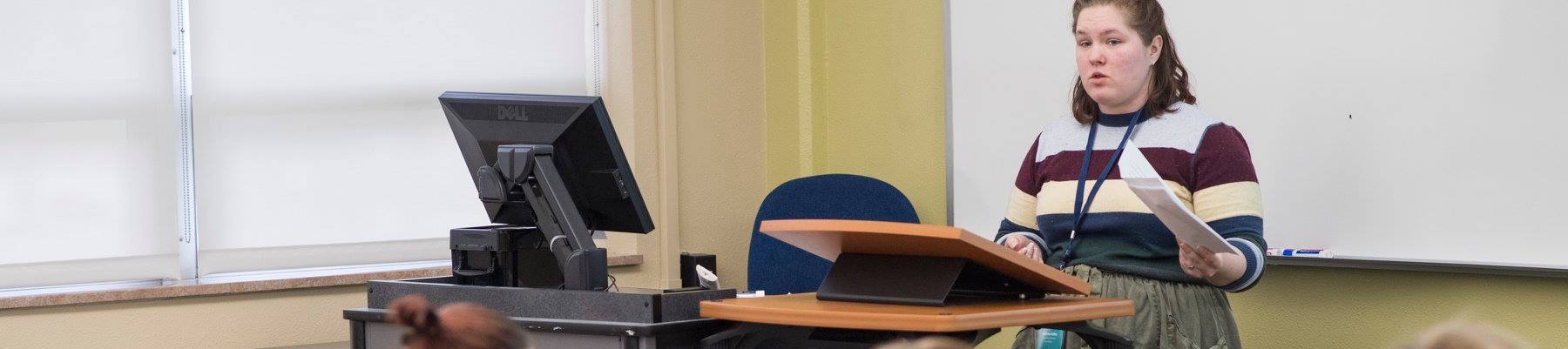 Picture of student speaking at a conference.