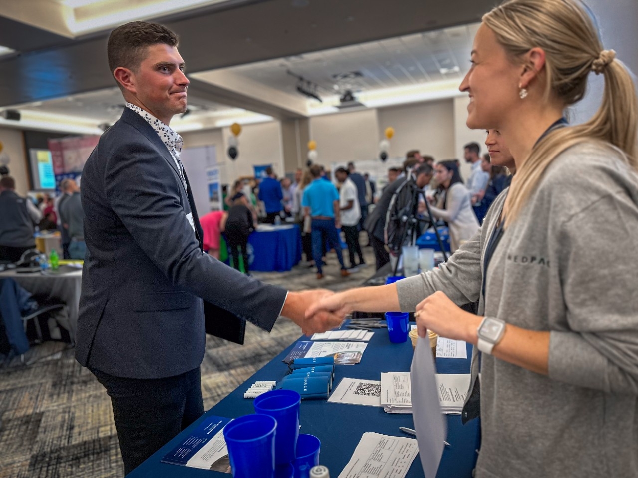 An NKU student shakes hands with an employer representative at a Career Connections event.