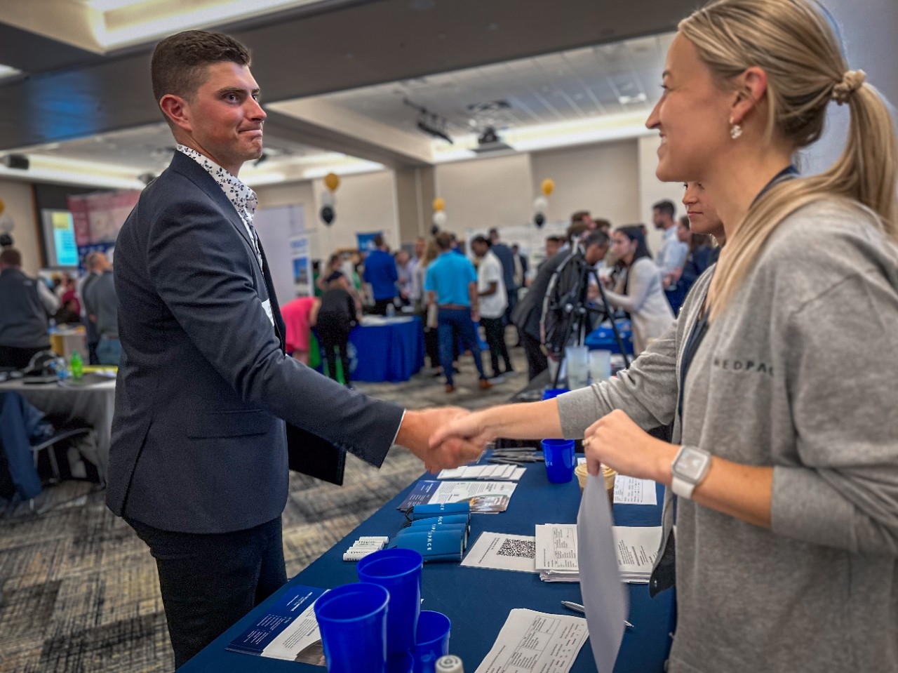 An NKU student shakes hands with an employer representative at a Career Connections event.