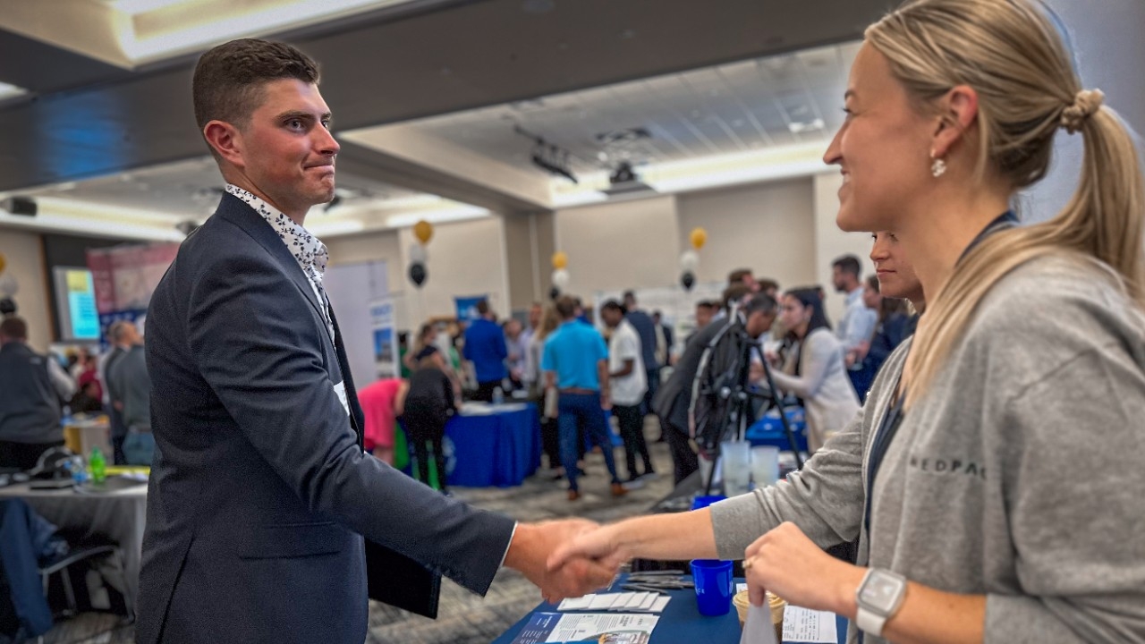 An NKU student shakes hands with an employer representative at a Career Connections event.