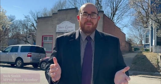 Man standing on street in front of building