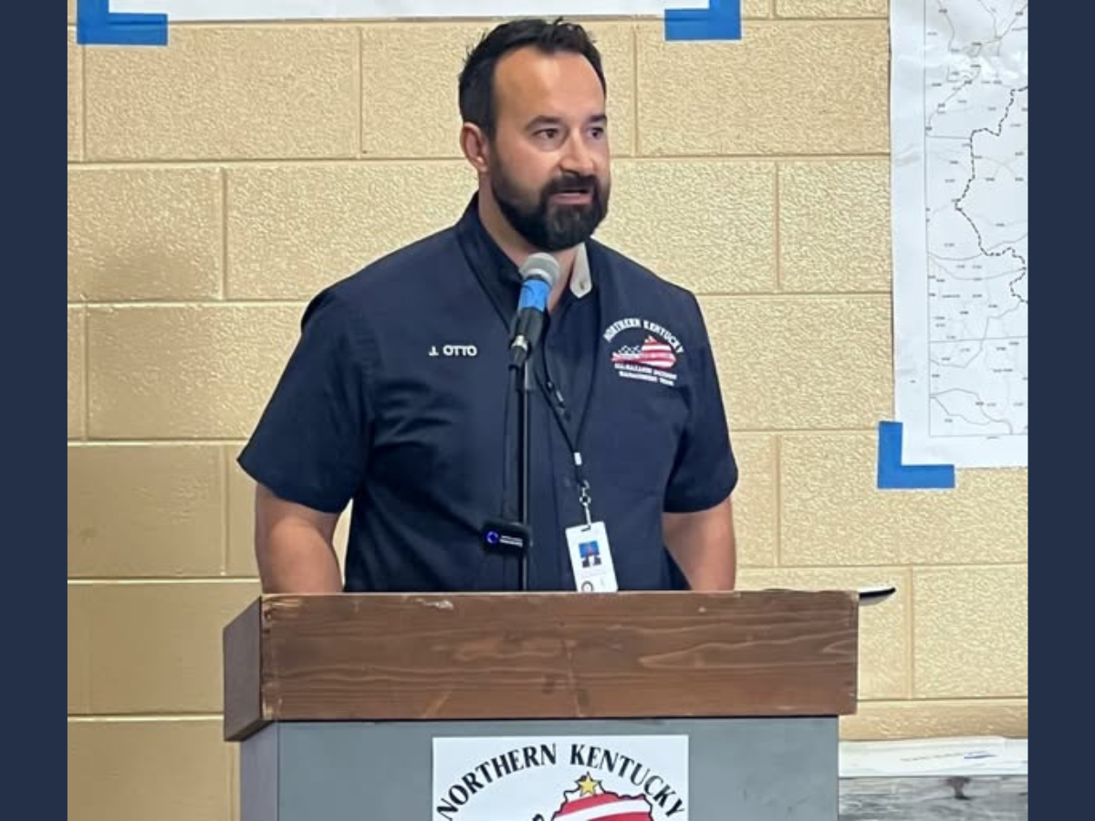 Untitled design - 1 Justin Otto standing at a podium