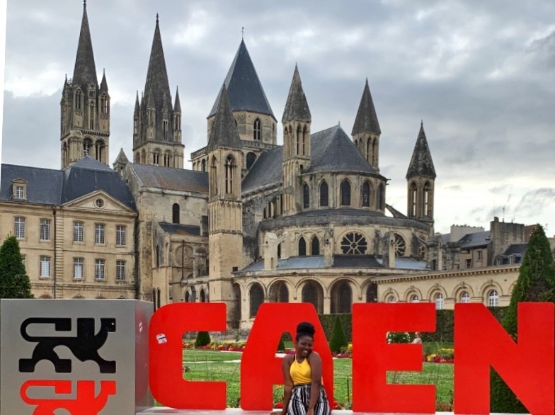 Student posting in front of German castle.