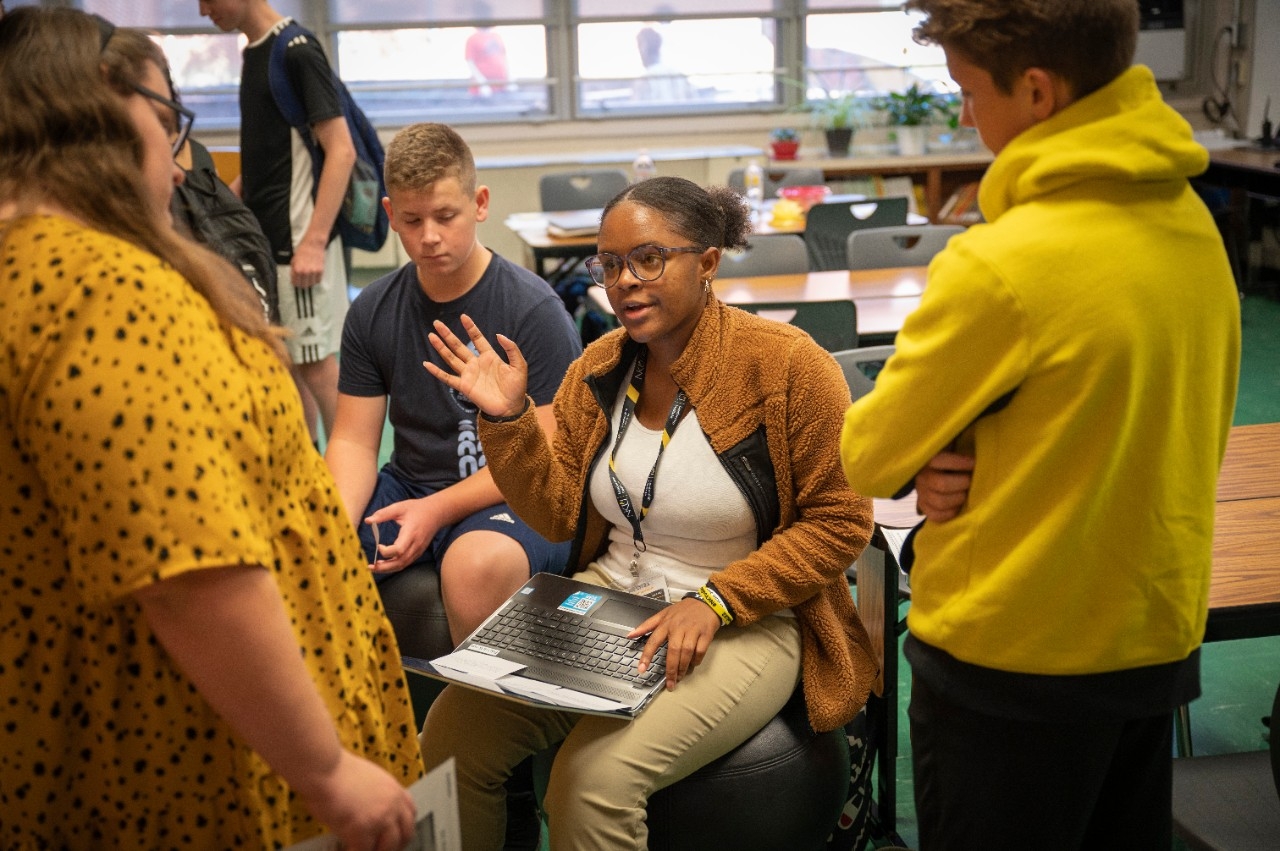 Students gathered around in a discussion