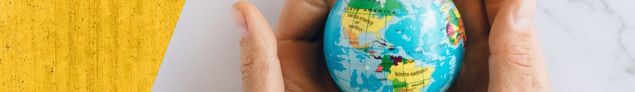 Hand holding a small globe