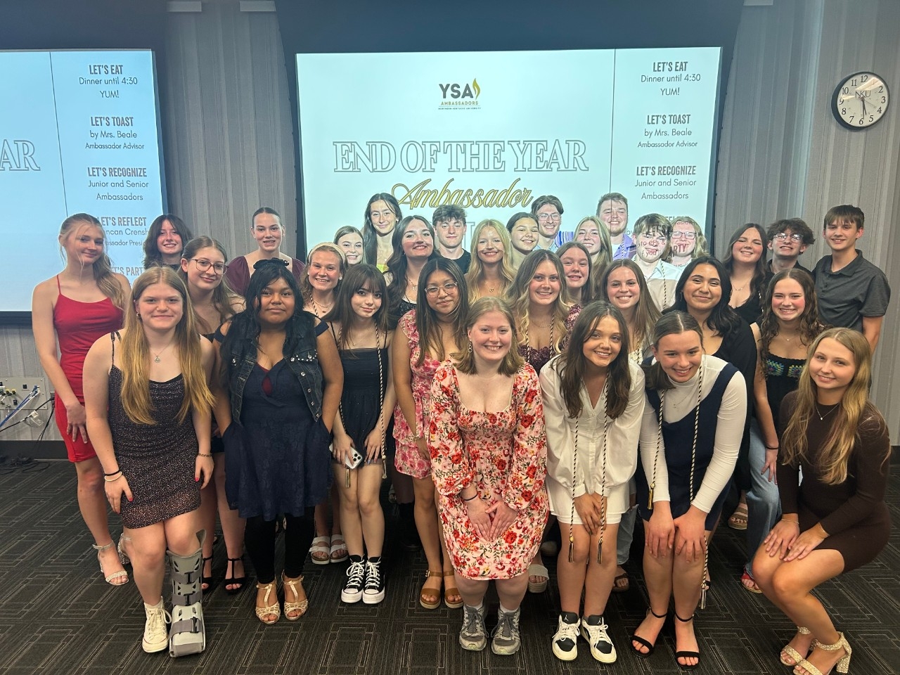 group of students in front of a presentation