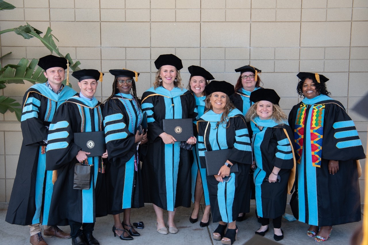 Ed.D. Graduates posing in doctoral robes