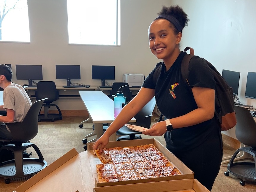 Photo of NKU student eating pizza