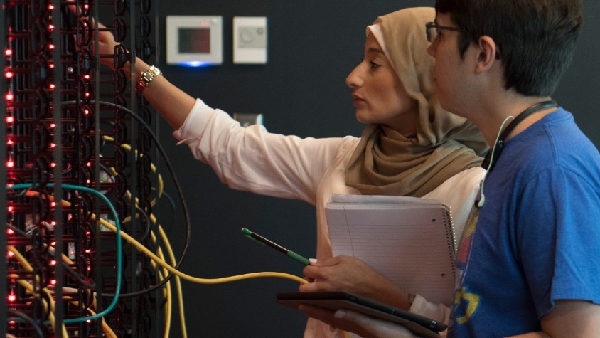  Two students looking at a server rack
