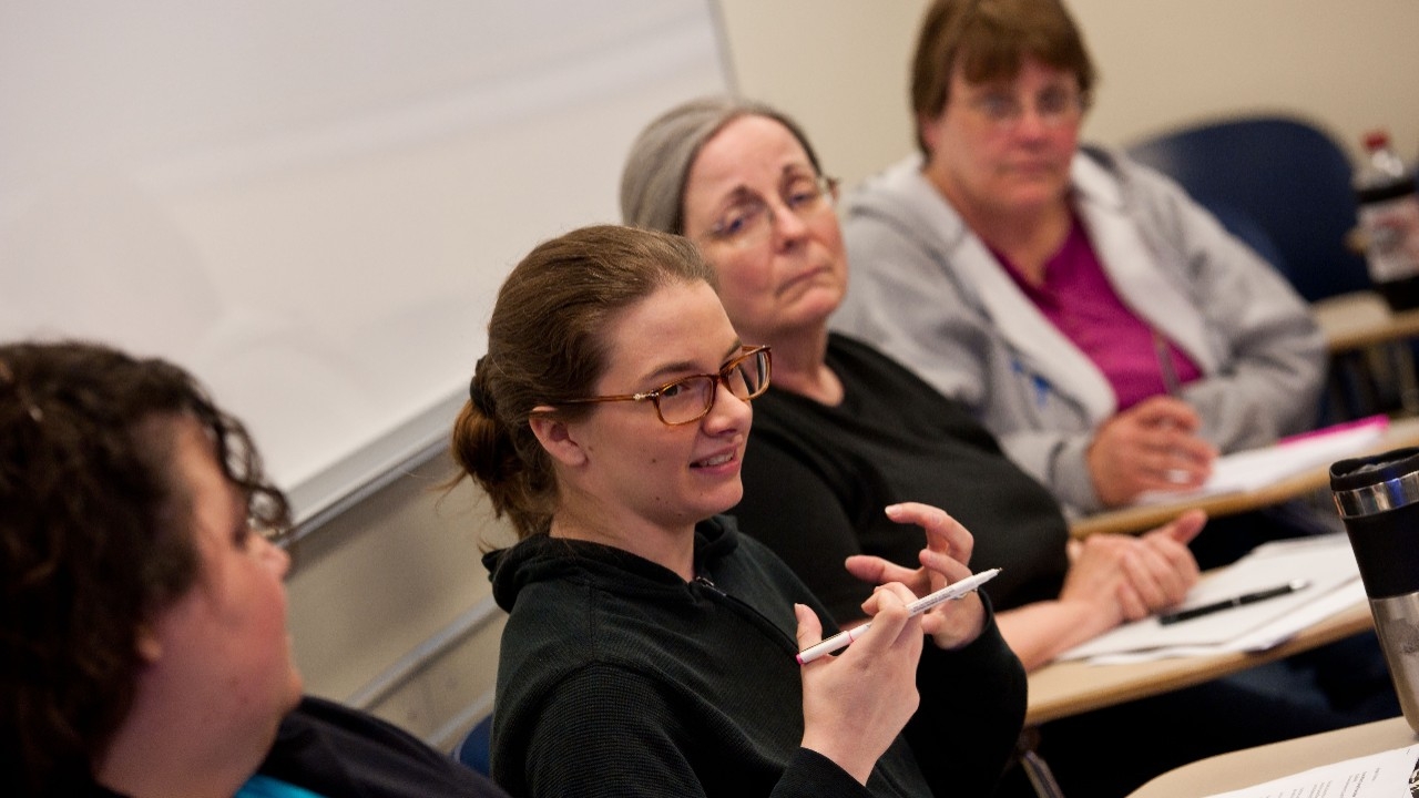 Grad students discussing topics during class