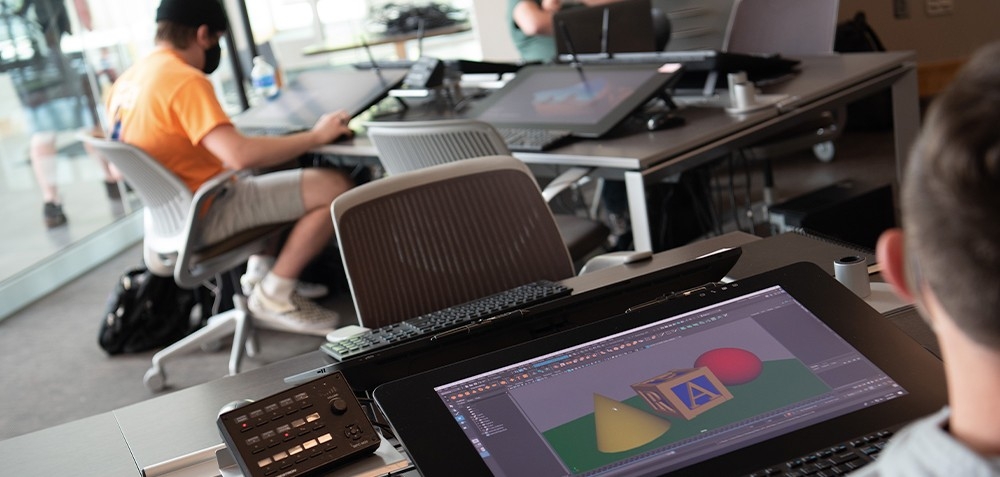 computer lab with tables supporting monitors and peripherals 