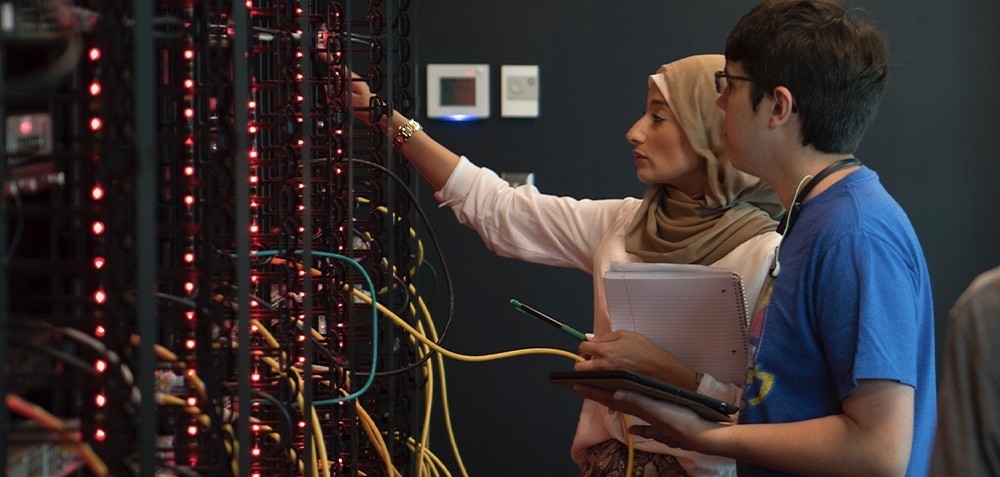 Computer server room with two lab techs