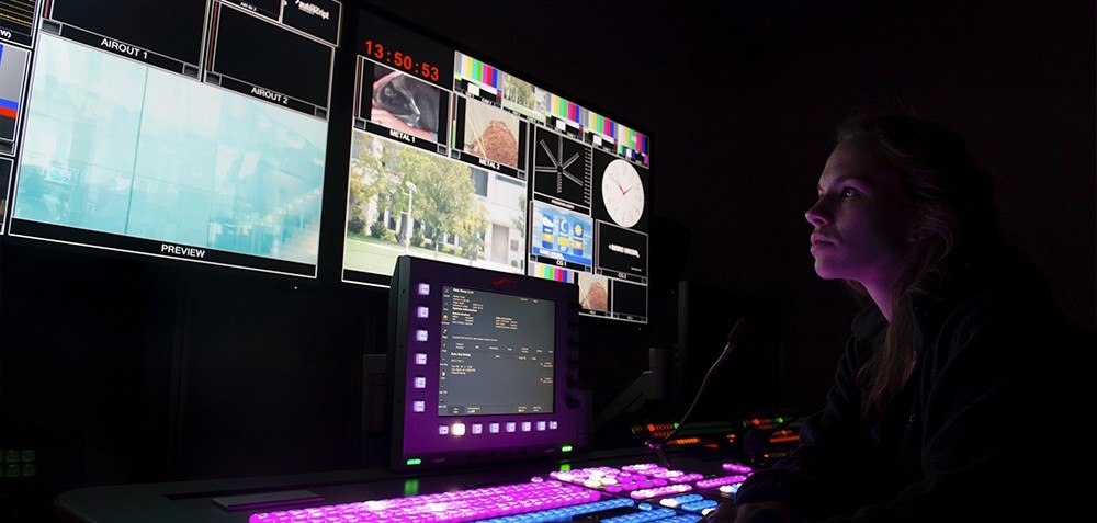 Controle room in COI building with colorful lights and a female tech on the right