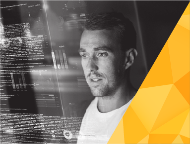 COI technology image with a student looking at screens and a decorative yellow angle in the lower right corner