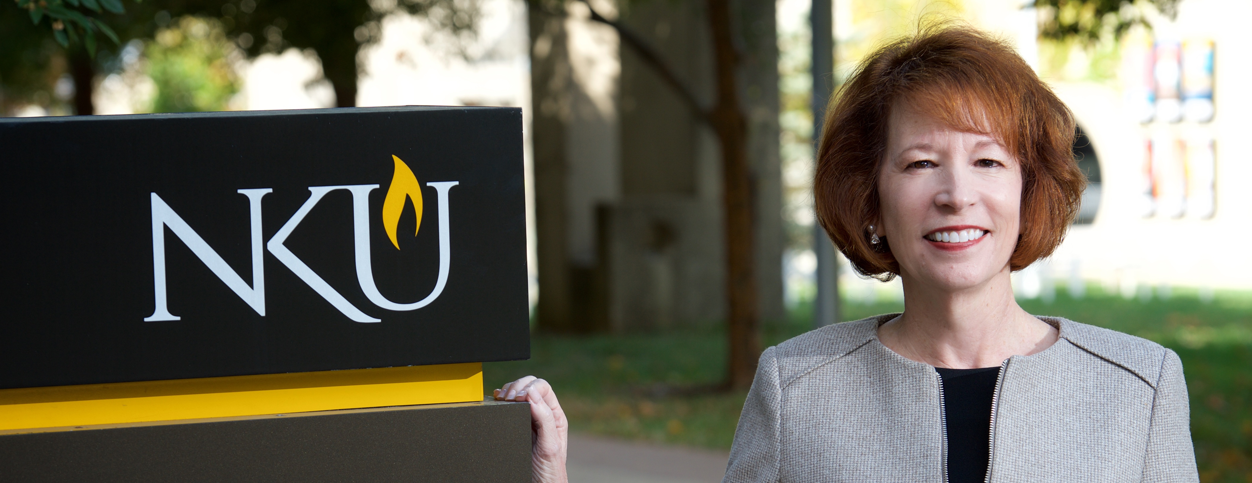 Dean Judith Daar standing outside by NKU Chase sign