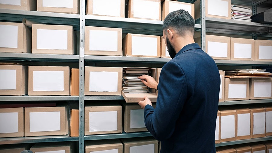 Man with documents in archive