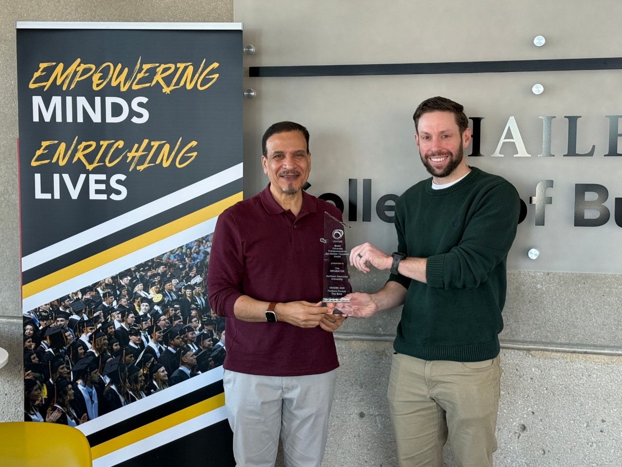 Dean of the Haile College of Business Hassan HassabElnaby and Zac Strobl, Director of the Center of Innovation & Entrepreneurship, pose with the National Model University Accelerator/Incubator Program Award. 