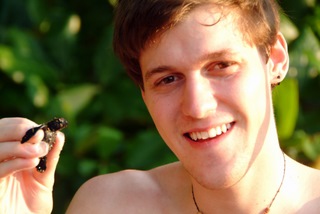 Erik Durtsche holding a baby sea turtle