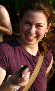 Casey cutter holding a baby sea turtle