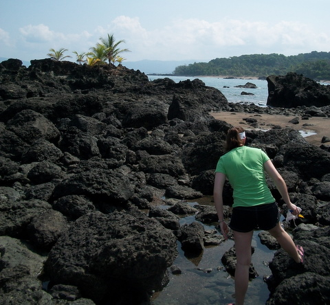 Katie Bachman on rocks by the sea