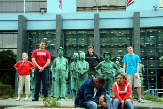 Diana, Osniel, Erik, and Jeff all pose in with the statues