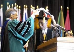 NKU President James Votruba confers an honorary degree on the Rev. Fred Shuttlesworth, who has a long history in the nation's civil rights movement.