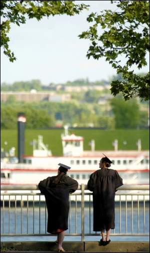 In a moment of reflection, Danielle Steele (left) of Taylor Mill and Patty Corbett of Covington watch the river before lining up.